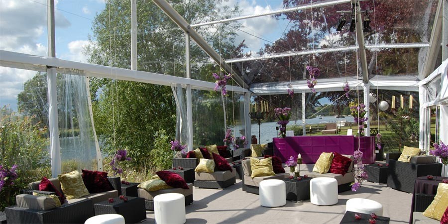 Internal photo of a marquee with clear roofs, walls and gables